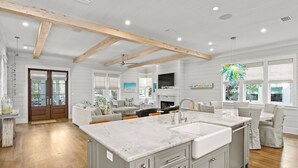 A spacious kitchen with a large island, wooden beams, and a modern design. - Beach Access and Private Pool (Watersound)