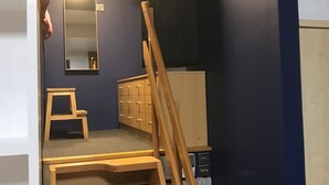 A room with a bunk bed, a small wooden stool, a mirror, and a cabinet with drawers. - Stylish Open Plan Loft in Manchester City Centre (Manchester)