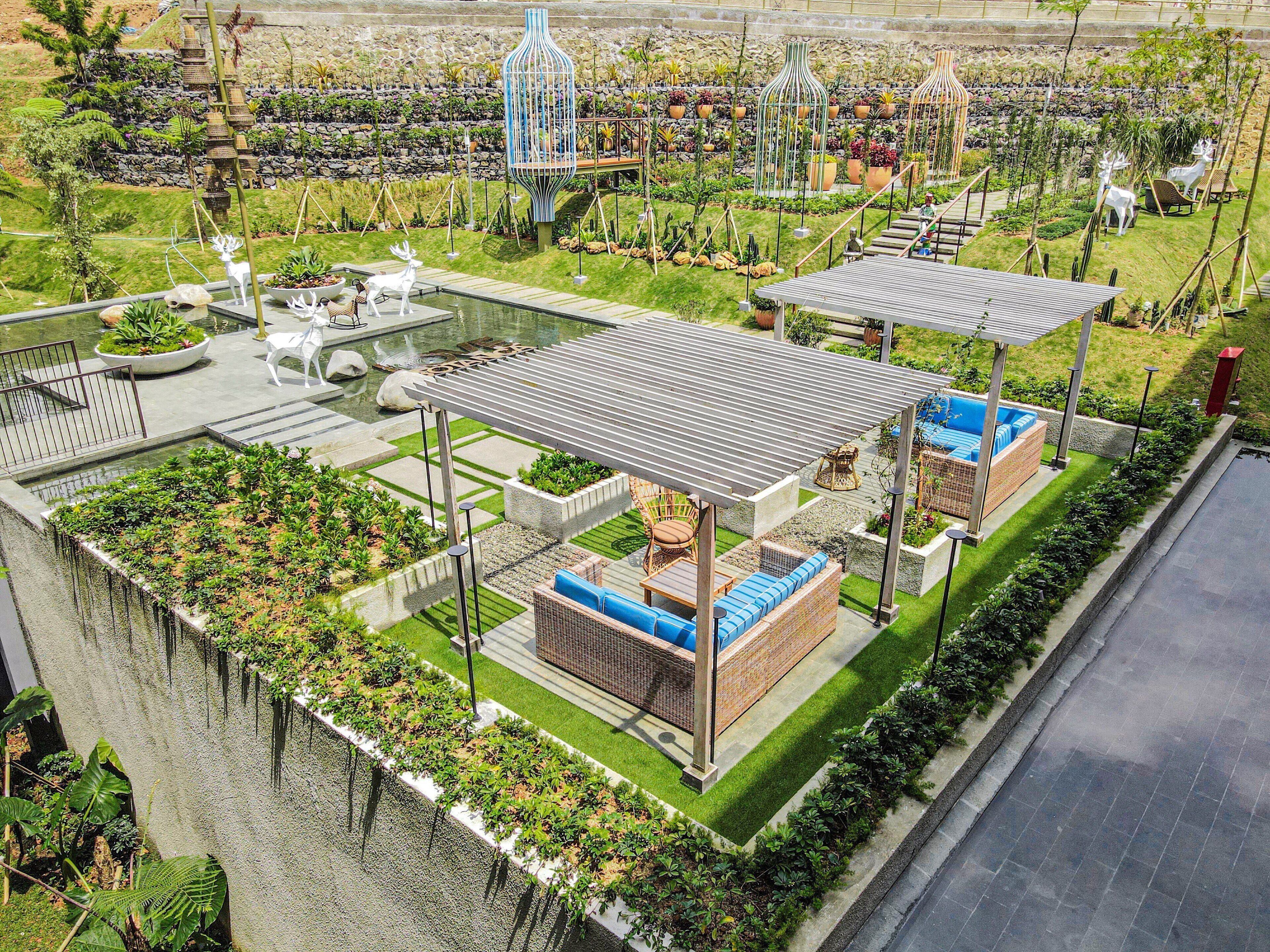 A rooftop garden with a pool, seating areas, and a pergola.