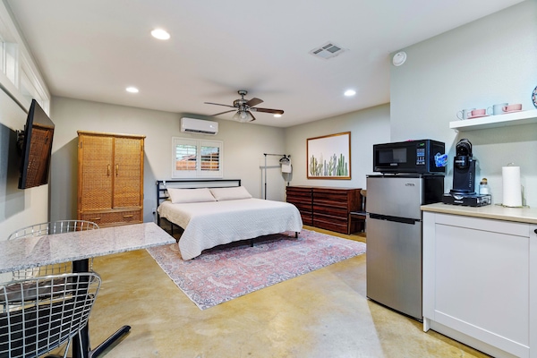 Main studio area includes king bed, tv, kitchenette & dining table.