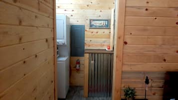 A laundry room with a sign indicating it's for guests' use.