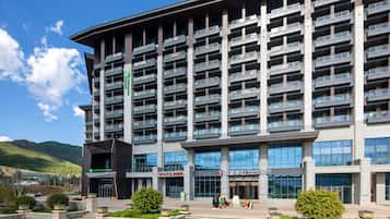 A multi-story hotel with balconies, a Holiday Inn Express sign, and a Tourist Centre.