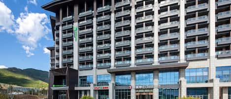 A multi-story hotel with balconies, a Holiday Inn Express sign, and a Tourist Centre.