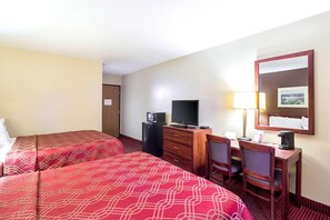 A hotel room with two beds, a desk with a computer, a TV, and a mirror. - Americas Best Value Inn Fargo (Fargo)