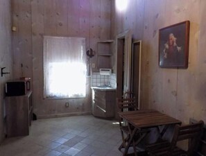 Cozy cabin retreat with a kitchenette, microwave, and sink, plus a comfortable seating area.