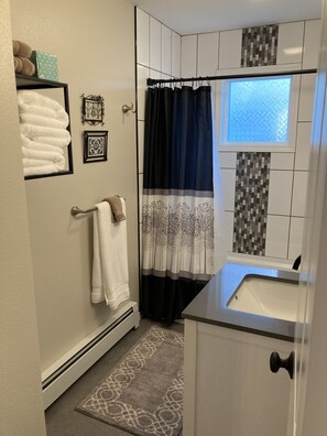 Combined shower/tub, hair dryer, towels, soap