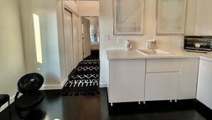 A modern kitchen with white cabinets, a built-in oven, and a microwave. - The No. 3: modern, bright, renovated, dwtn condo w/ outdoor lounge space (Marfa)