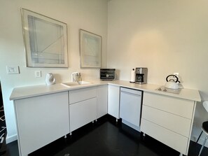 Fridge, stovetop, dishwasher, coffee/tea maker