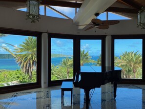 Enjoy a panoramic view of the tropical landscape from the large window in this spacious room.