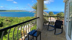 A balcony with a view of the ocean and a stone floor. - Sea Views Villa & Guest House with 2 Private Pools. In a Private Club (St. Paul's)