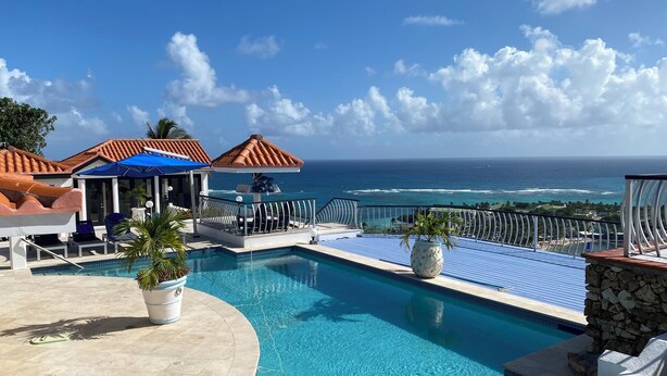A pool area with a view of the ocean, lounge chairs, and umbrellas. - Sea Views Villa & Guest House with 2 Private Pools. In a Private Club (St. Paul's)