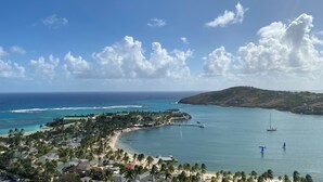 A coastal resort with beachfront properties, a marina, and a view of the ocean and hills. - Sea Views Villa & Guest House with 2 Private Pools. In a Private Club (St. Paul's)