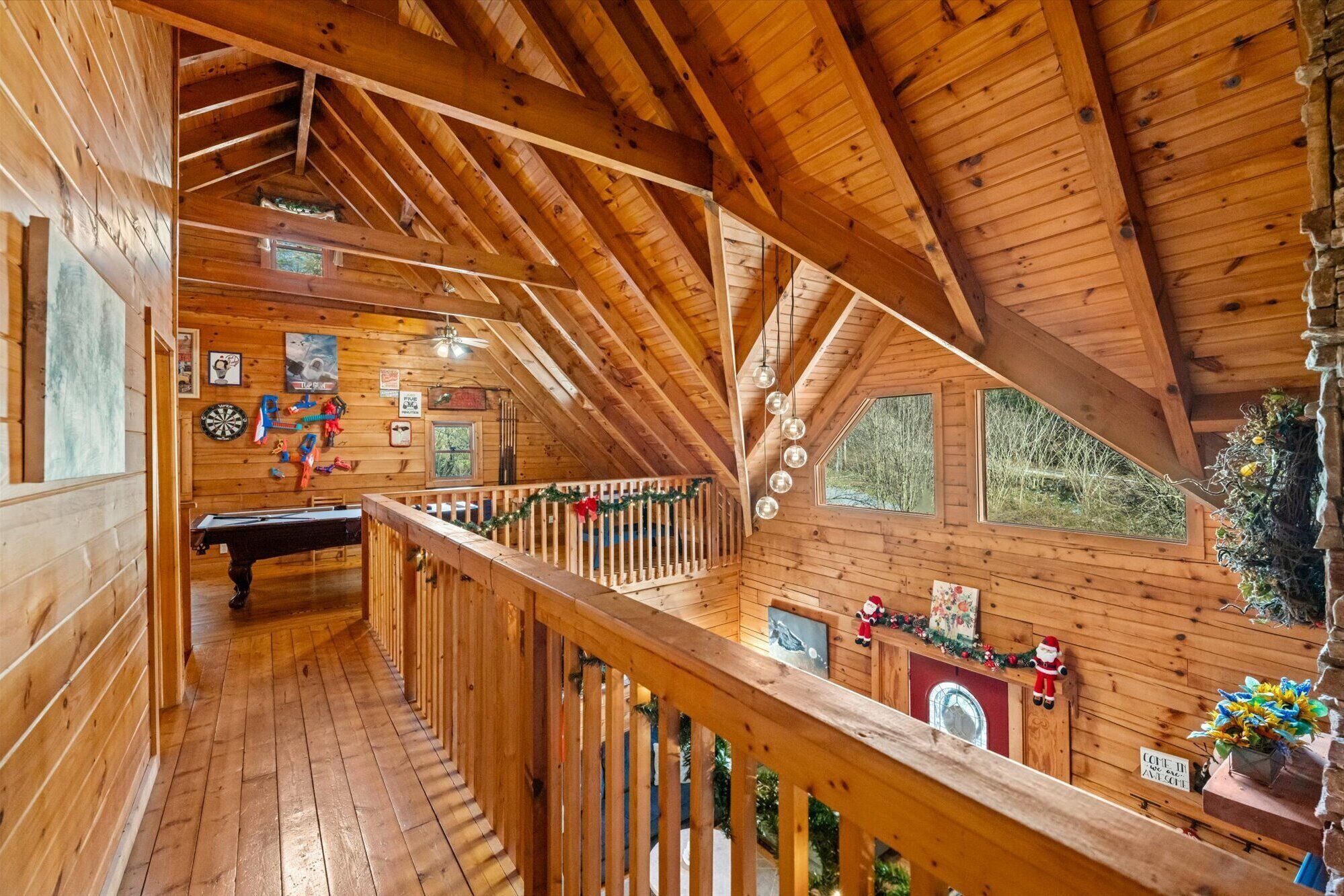Eine Holzhütte mit Schlafzimmer auf dem Dachboden, Essbereich und Küche.