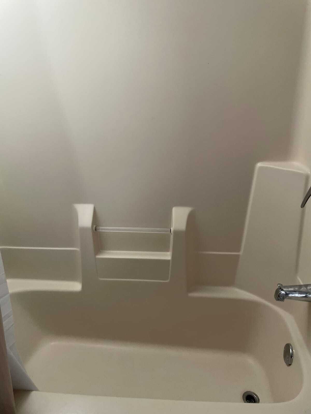 Tina con regadera, toallas, papel de baño 