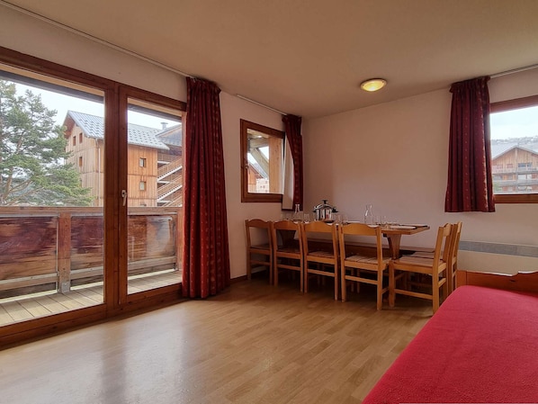 Enjoy a meal at the table by the window, with a view of the surrounding buildings.