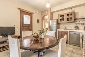 Enjoy cooking in this well-equipped kitchen with a central island, flat-screen TV, and stainless steel appliances.