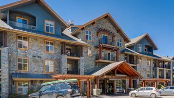 A multi-story lodge with stone facade, balconies, and a covered entrance.