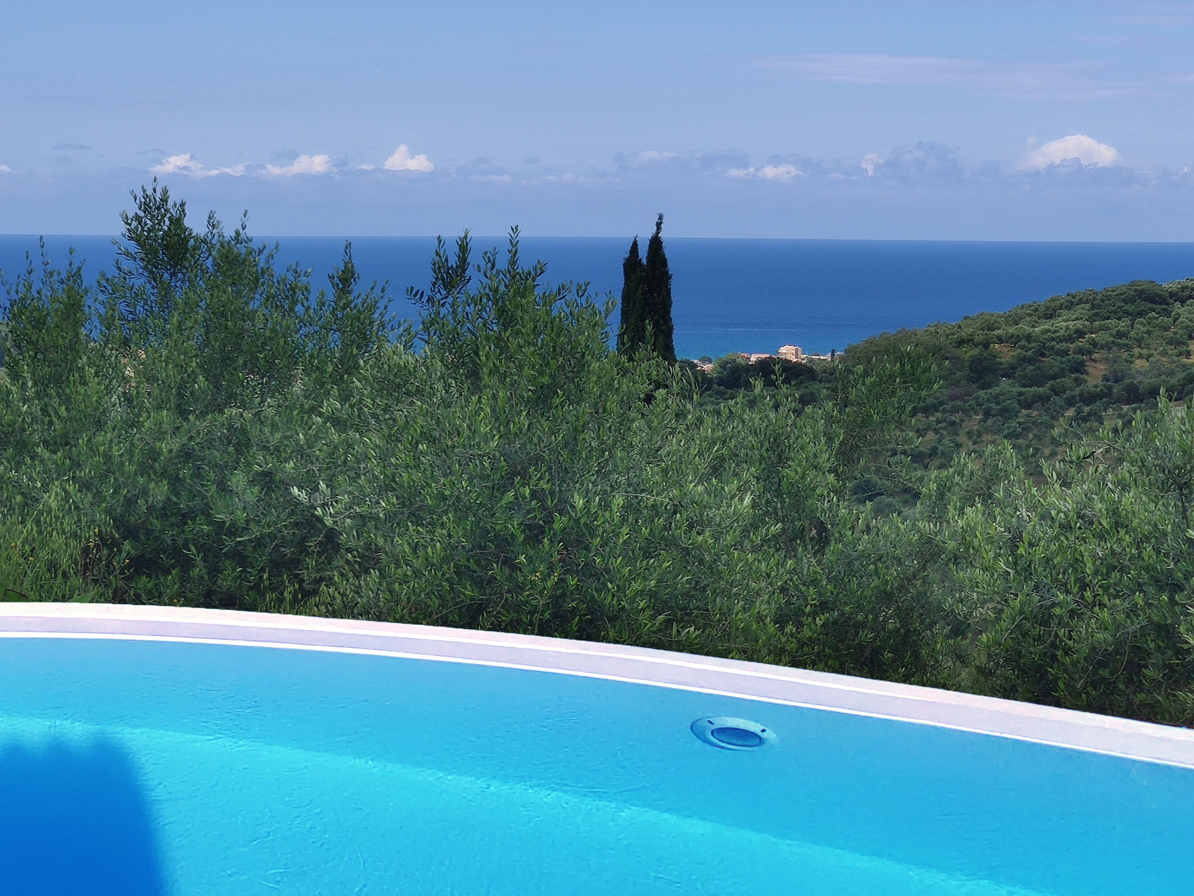 Una piscina al aire libre, sillones reclinables de piscina