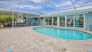 A pool area with a covered patio, seating, and a bar. - All Docked Out-Bring Your Own Boat! Private Heated Pool, Free WiFi 3 Mins to AMI (Bradenton)