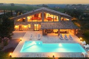 A two-story house with a swimming pool, outdoor seating, and a view of the countryside. - Villa Il Girasole in Parrano (Parrano)