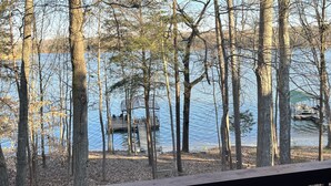 A view of a lake surrounded by trees, a dock, and a gazebo. - Cozy Lake Hartwell Cabin - Beautiful dock views! Bring your boat and your pet! (Lavonia)