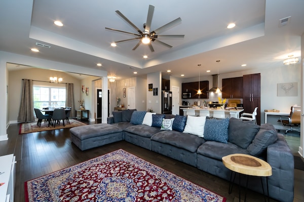 Living room with a large couch and modern accent pieces