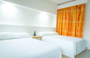 A hotel room with two single beds, a nightstand with a vase, and a bright orange curtain. - Hotel Acapulco (Acapulco)