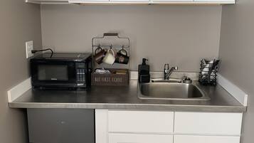 Fridge, microwave, coffee/tea maker, cookware/dishes/utensils