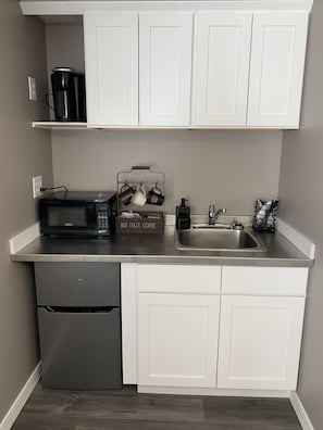 Fridge, microwave, coffee/tea maker, cookware/dishes/utensils