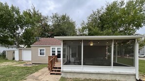 A single-story house with a covered porch, a front door, and a garage. - Pet Friendly Home by Lake Shawnee! (Topeka)