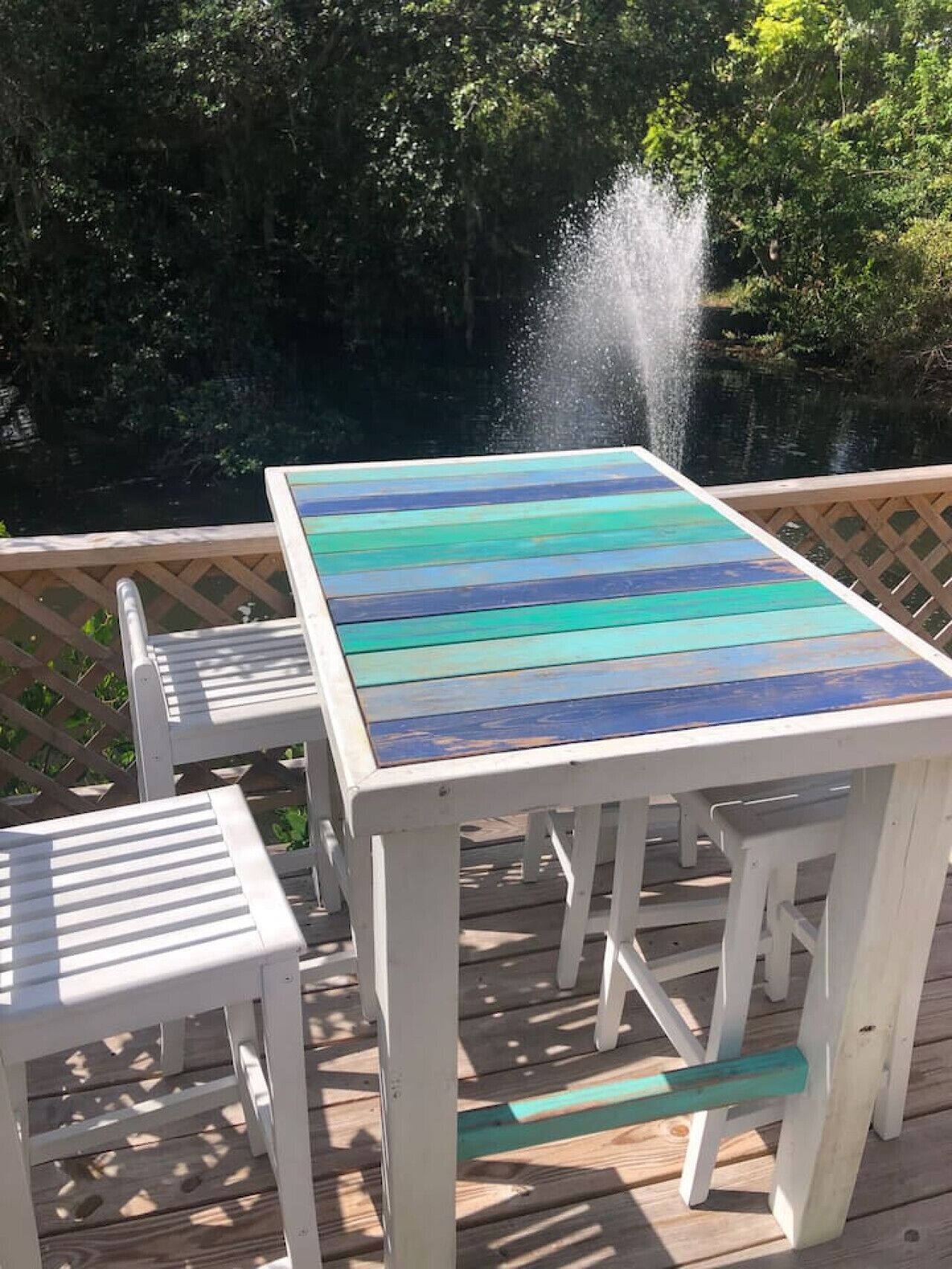 A wooden deck with a table and two chairs.