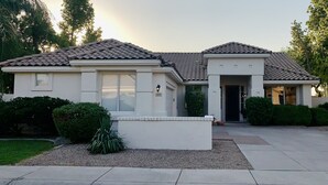 A two-story house with a tiled roof, a front porch, and a small garden. - Comfortable, clean, Spacious, relaxing home in metro-Phoenix area.🌵❤️🏡 (Chandler)