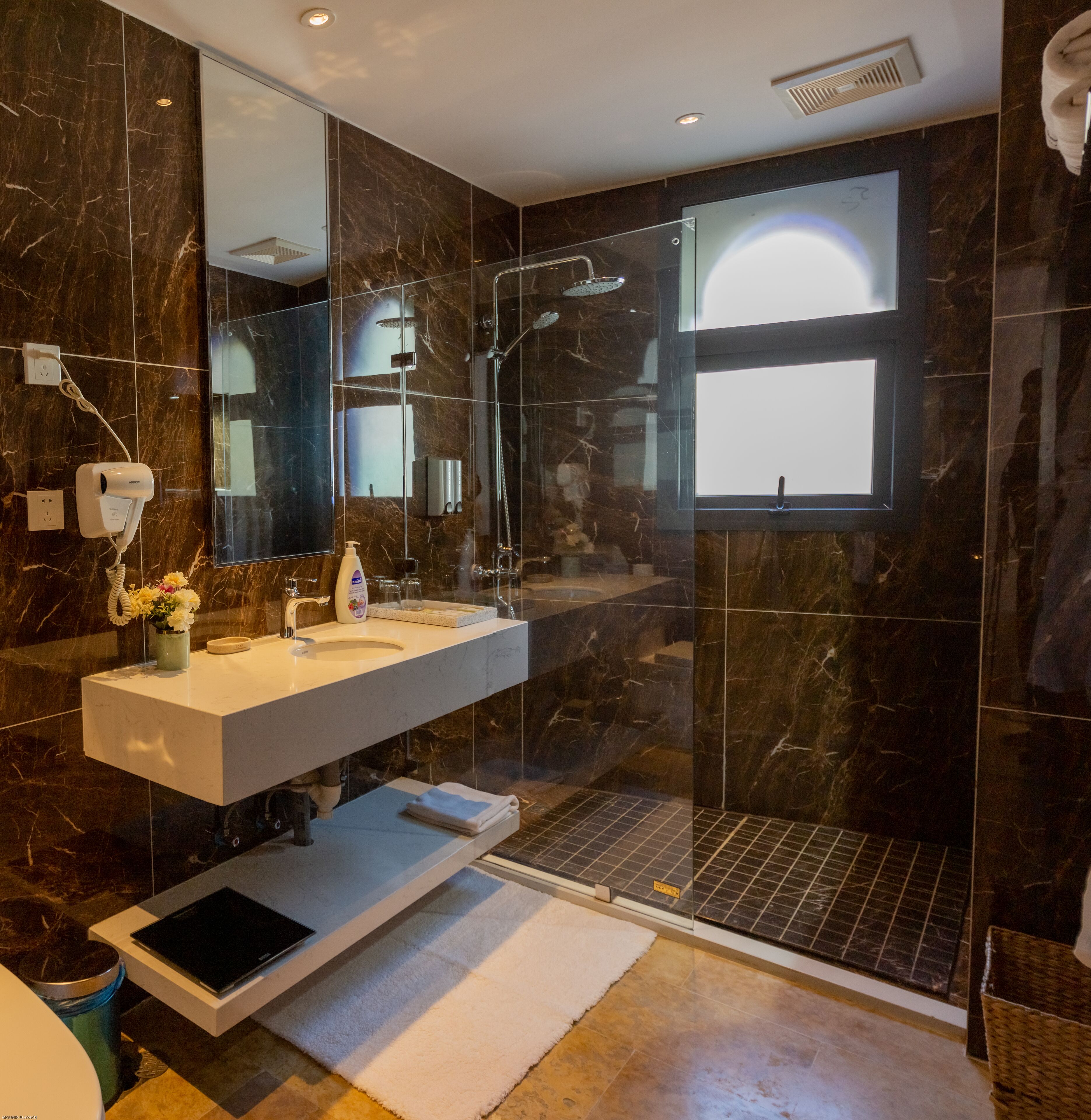 deluxe junior suite | bathroom | shower, hydromassage showerhead, hair dryer, towels