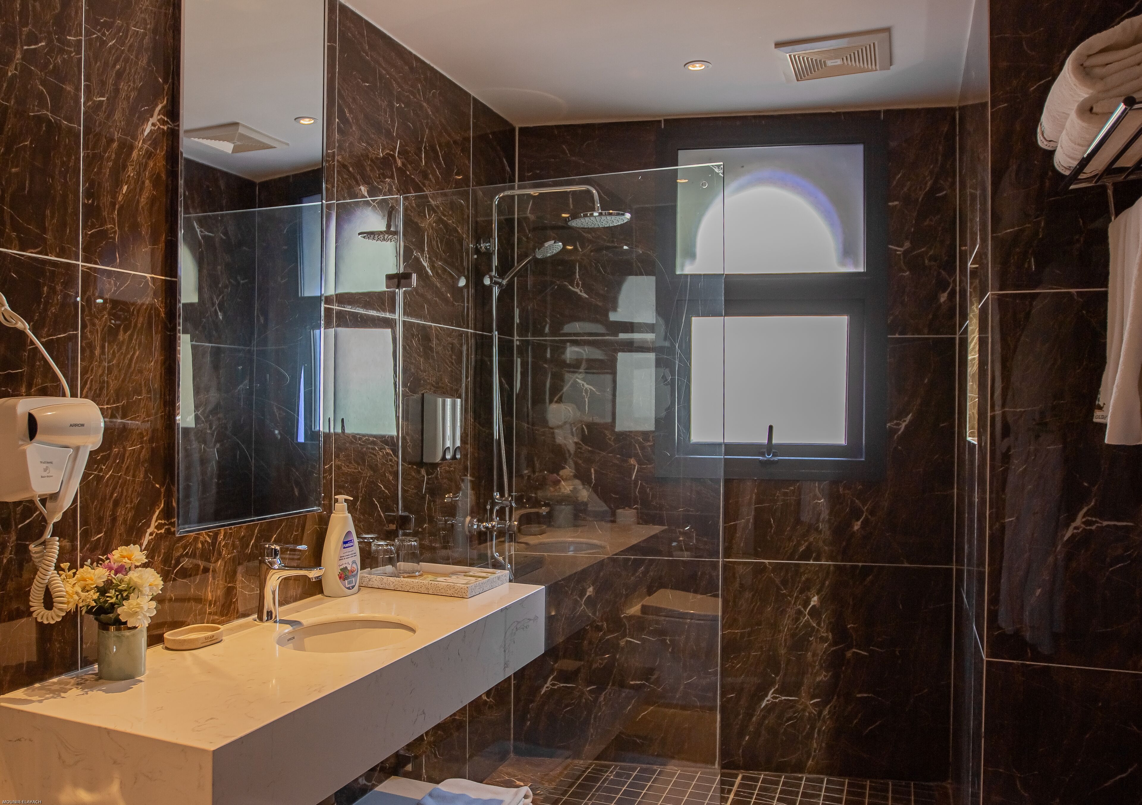 deluxe junior suite | bathroom | shower, hydromassage showerhead, hair dryer, towels