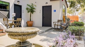 A courtyard with a fountain, potted plants, and outdoor seating. - Casa Valerio Unit 6C (Santa Barbara)