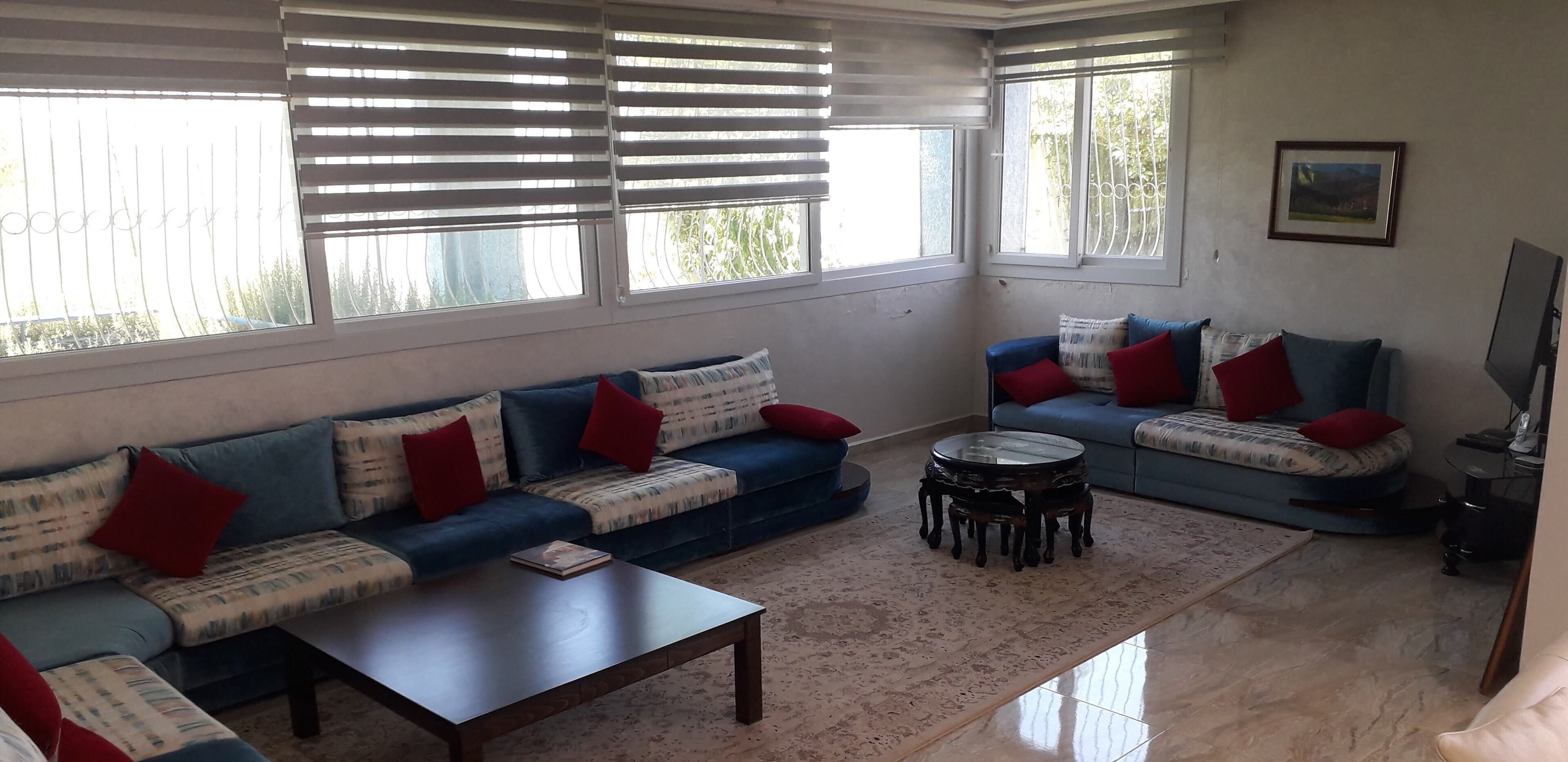 A living room with two sofas, a coffee table, and a TV stand.