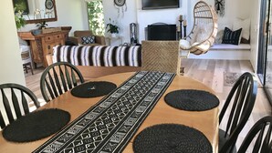 A dining area with a long table, black and white patterned runner, and black circular placemats. - Casa del Sol - Peaceful home away from home. (Santa Barbara)