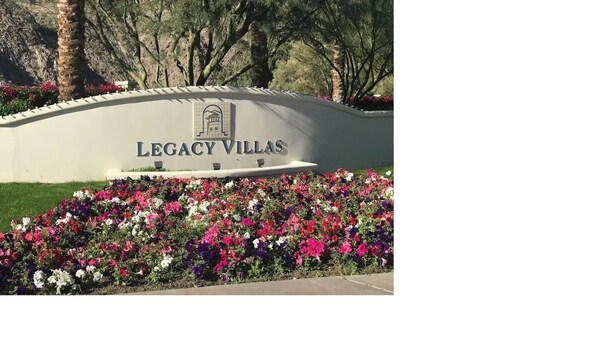 A sign for Legacy Villas with a landscaped garden in front. - New Listing - Lovely Mountain View Studio for two (La Quinta)