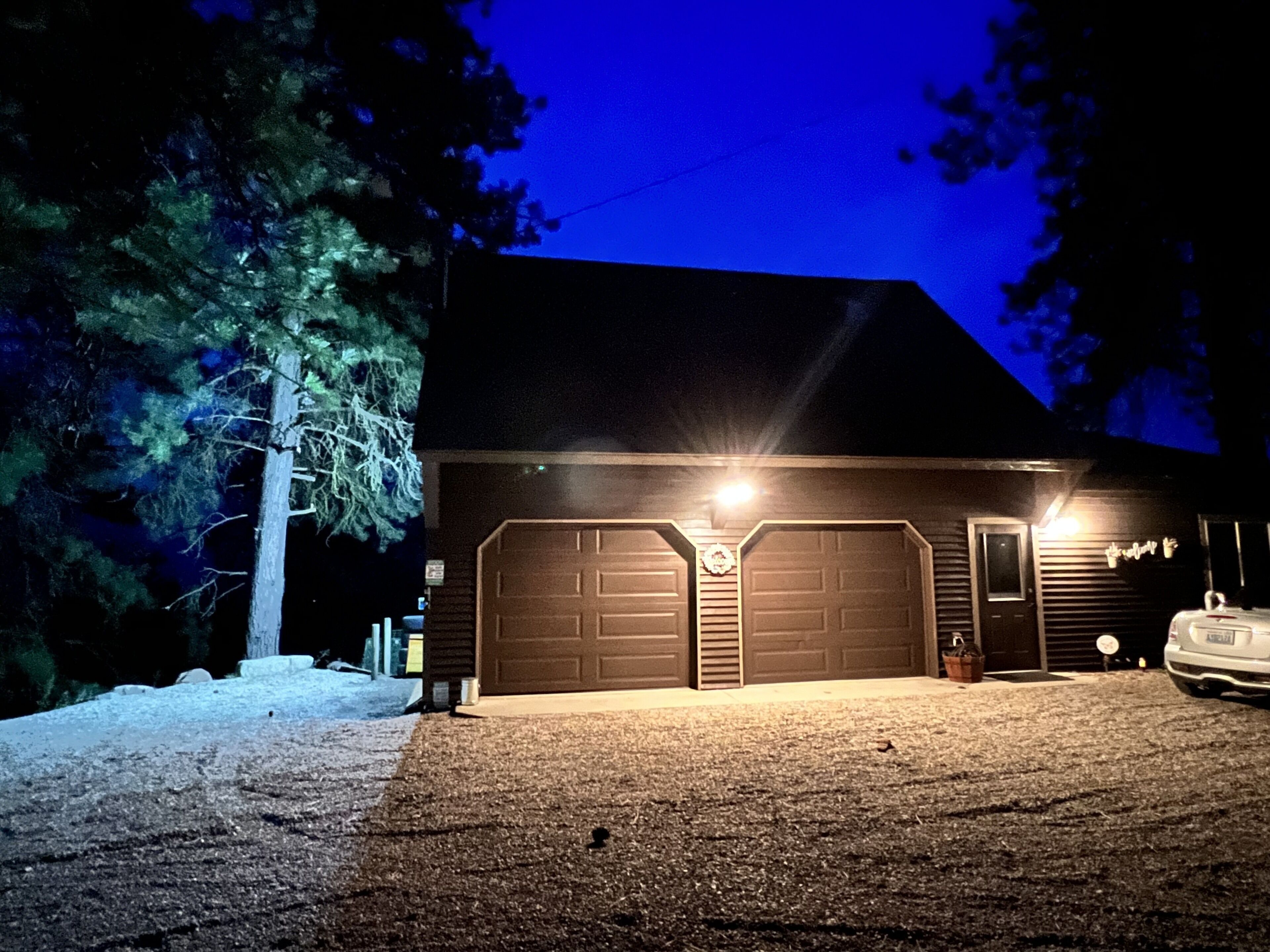 A two-story building with a garage and a driveway.