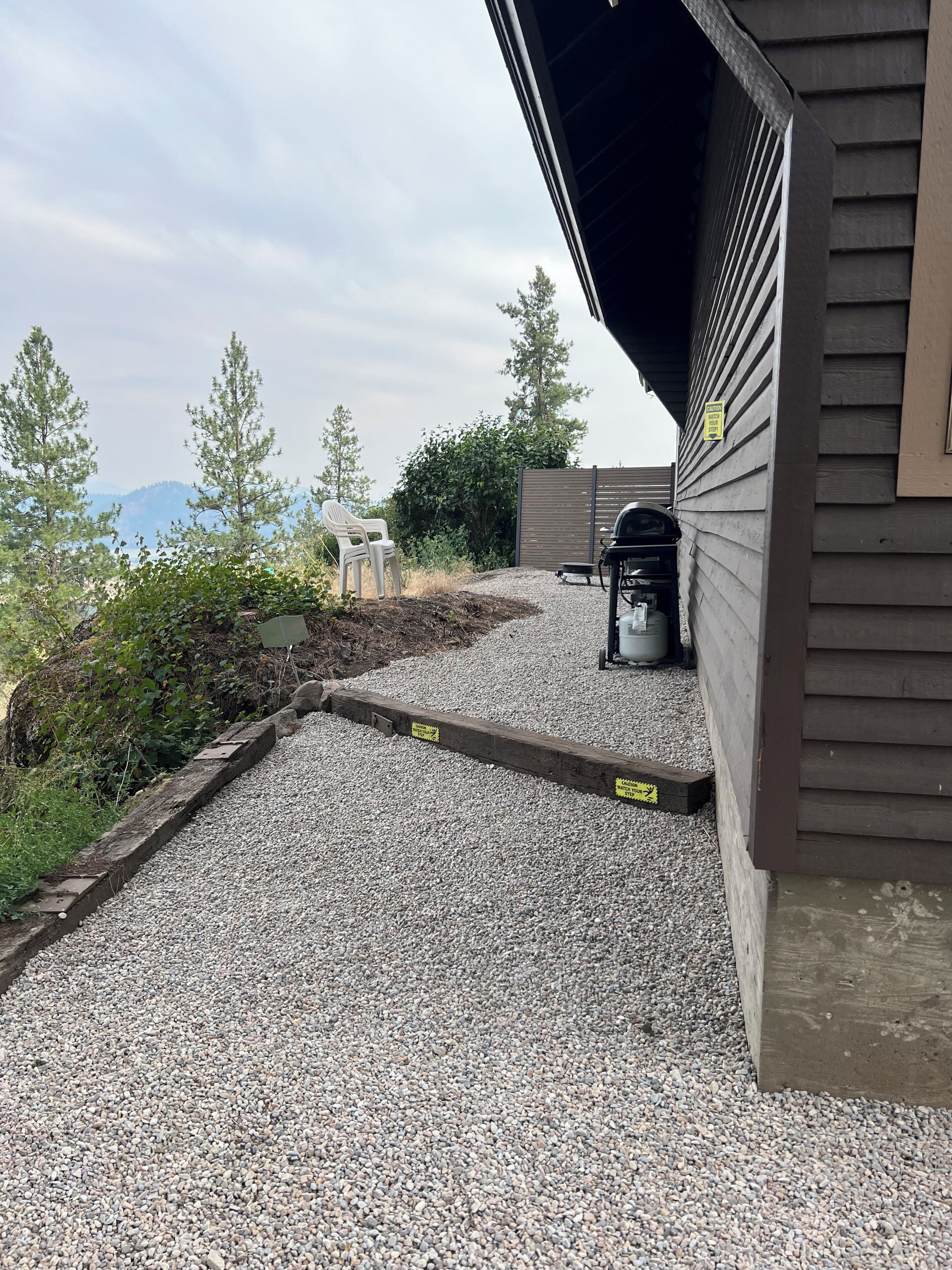 A gravel driveway leading to a building with a covered porch.