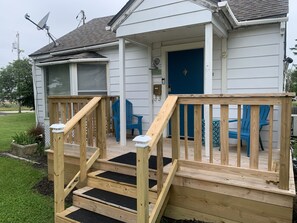 A wooden deck with a ramp leading to a blue door, surrounded by blue chairs. - Single family home 3 minute walk to everything downtown Fairborn offers. (Fairborn)