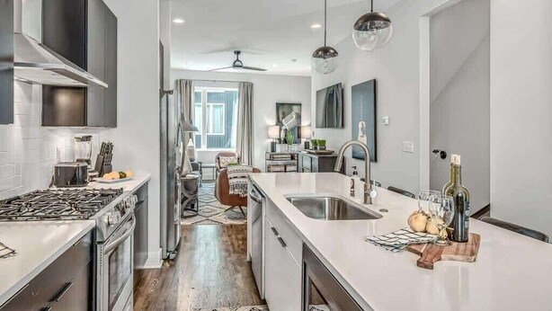 A modern kitchen with a central island, stainless steel appliances, and pendant lighting. - Nashville Cowgirl Stay – Rooftop Views (Nashville)