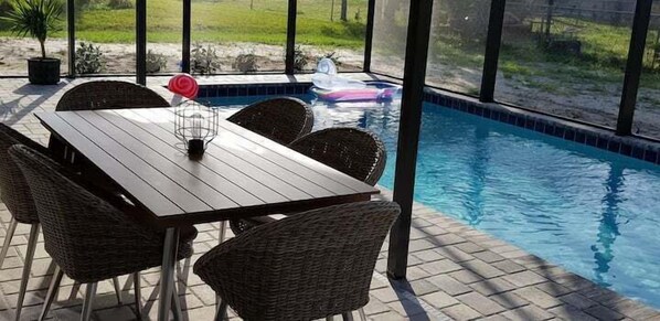 Relax by the pool surrounded by a grassy area and enjoy the tranquil atmosphere.