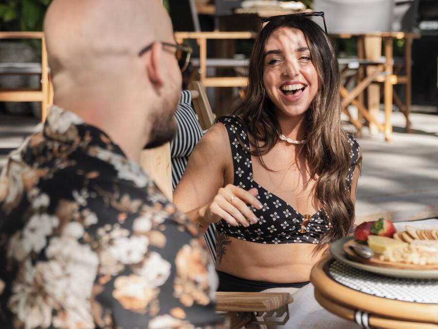 Een eethoek met houten meubels en een ronde tafel met een bord eten.