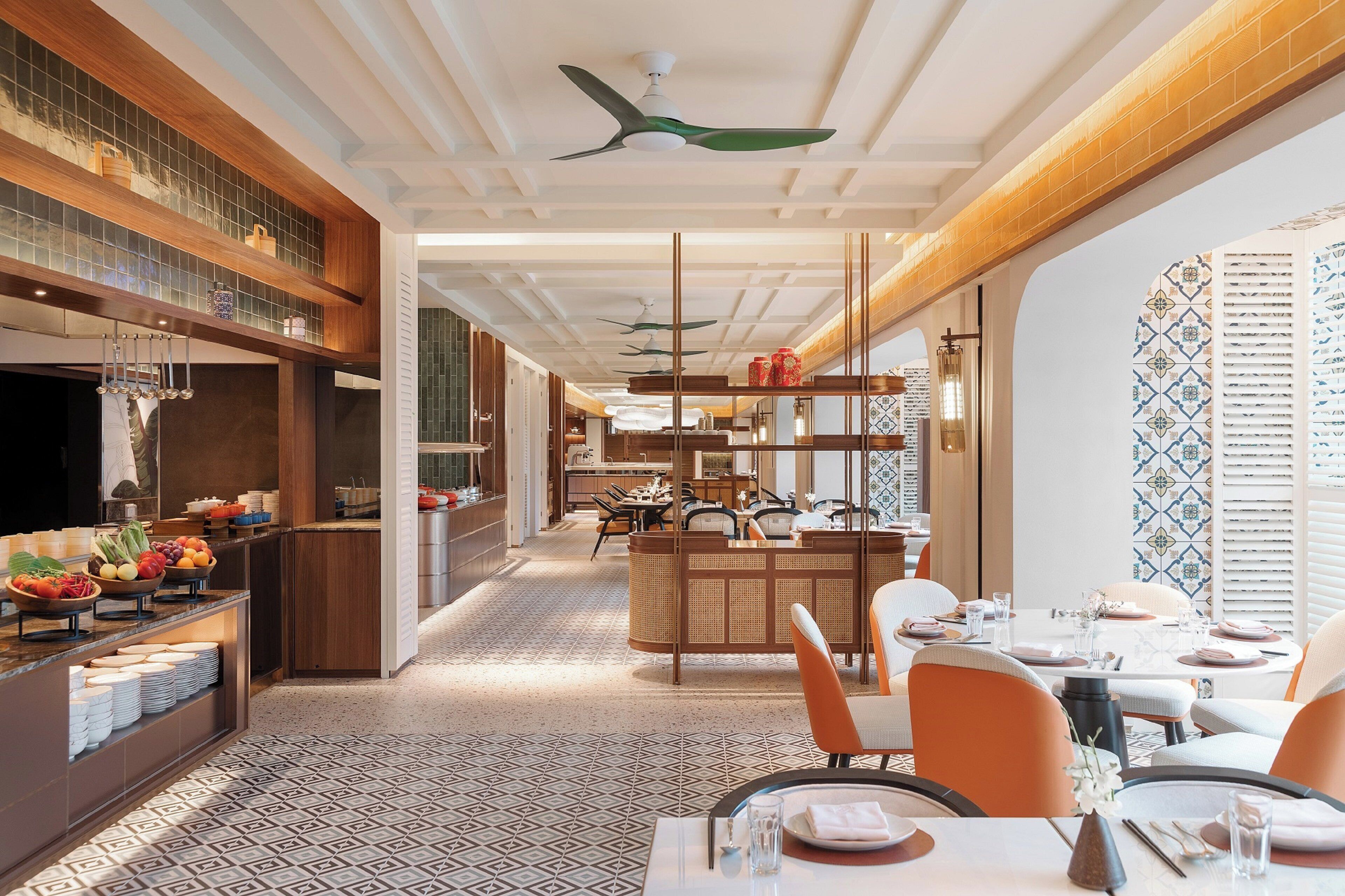 A modern restaurant interior with a central dining area, kitchen, and bar/lounge space.