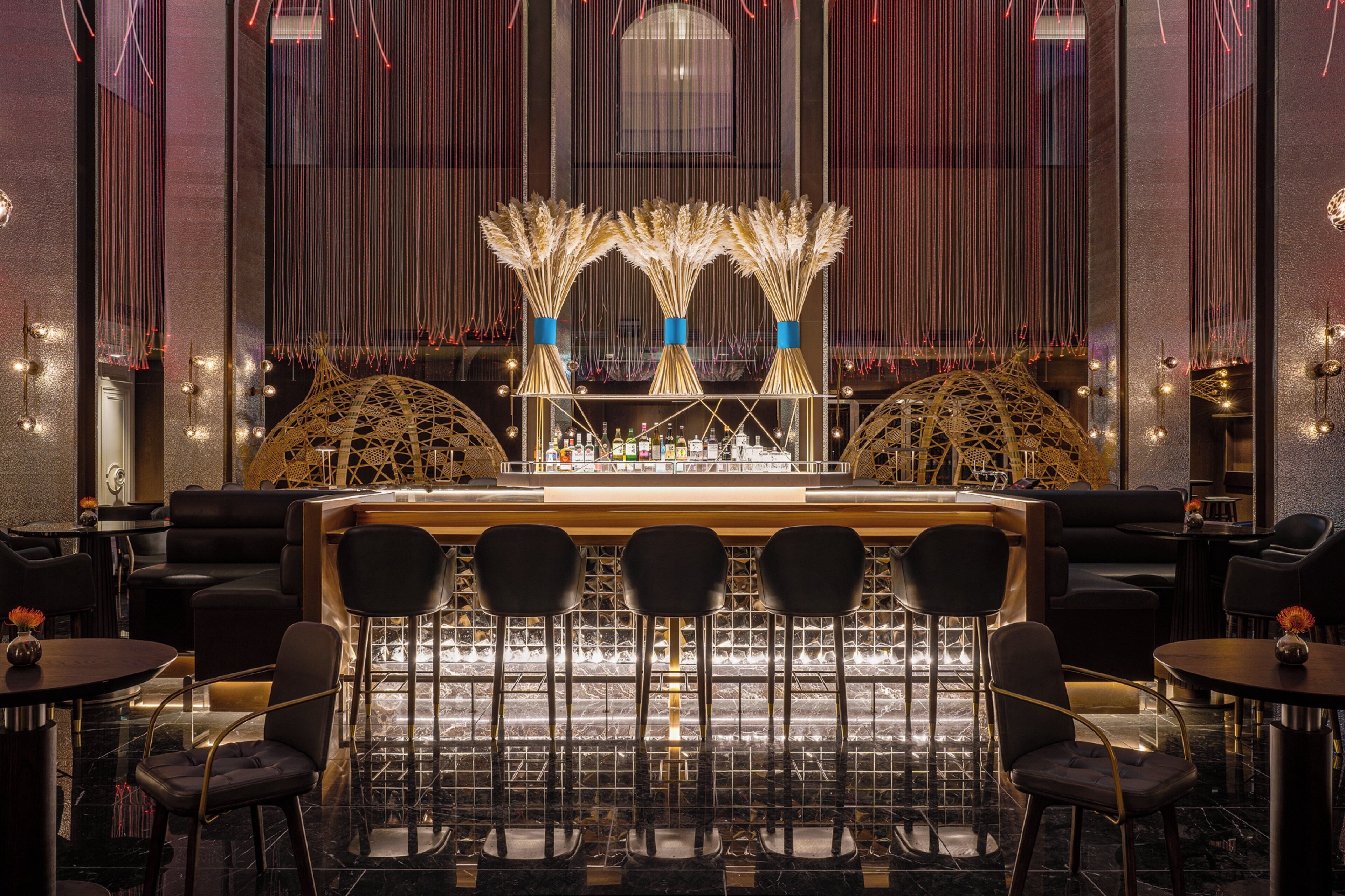 A bar area with a central counter, multiple seating arrangements, and decorative elements.