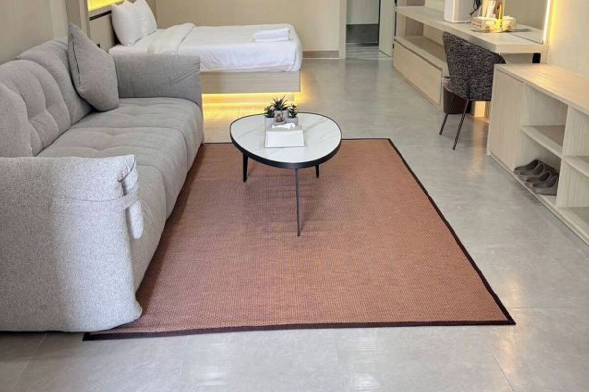 A modern living room with a sofa, a coffee table, and a small side table.
