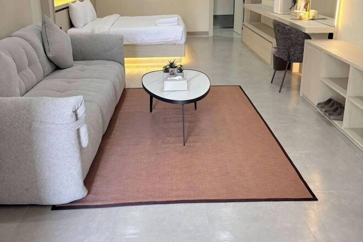 A modern living room with a sofa, a coffee table, and a small side table.