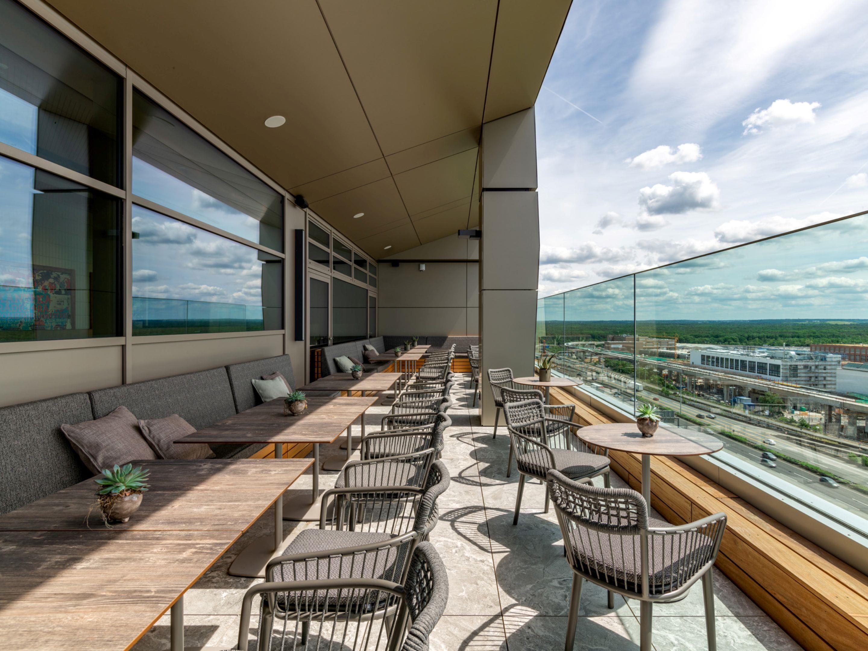 A modern outdoor seating area with a view of the cityscape.