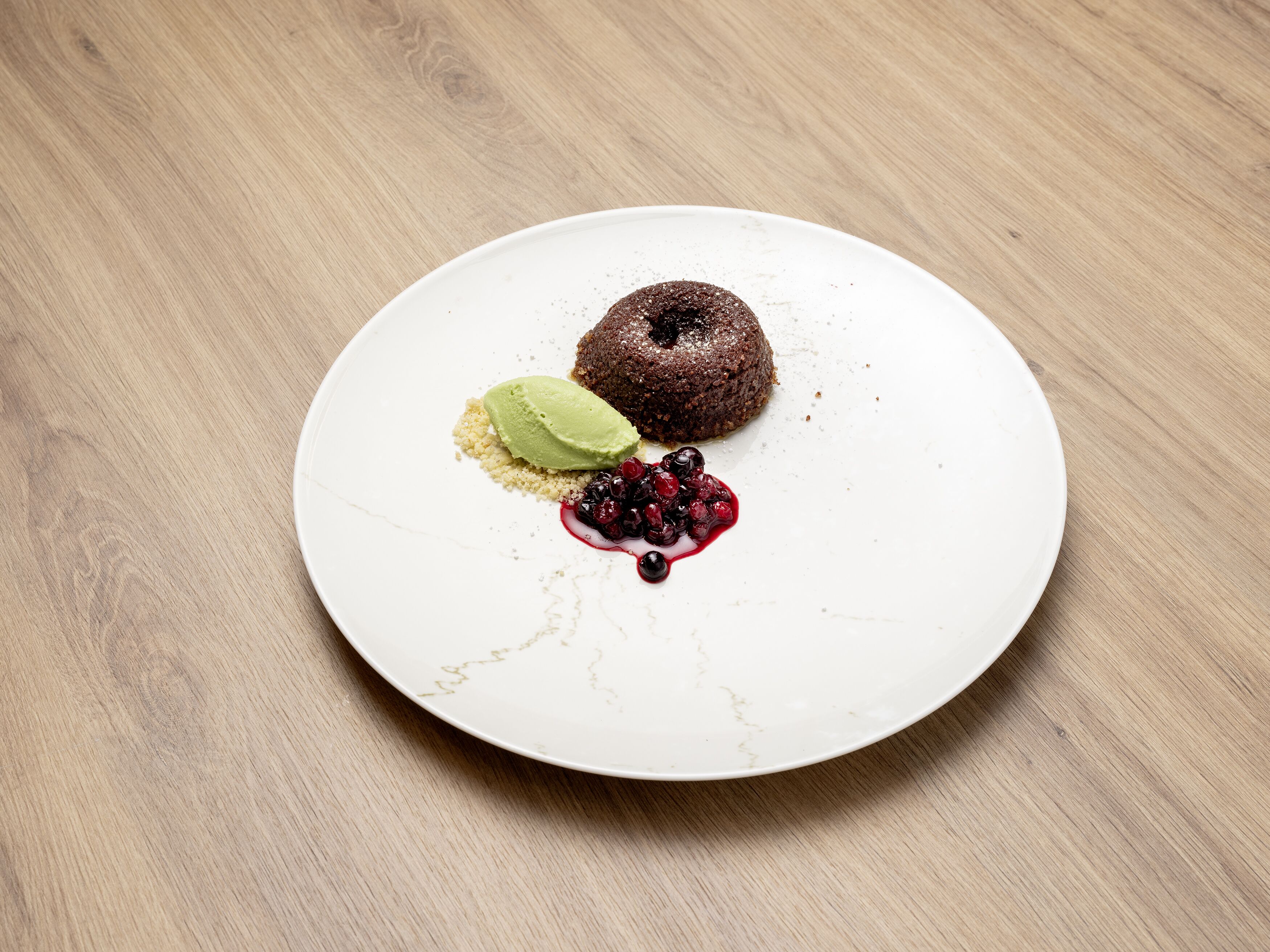 A dessert on a white plate with a wooden table background.